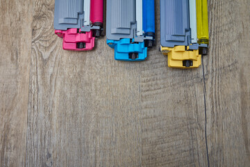Yellow, cyan and magenta toner cartridges on wooden table