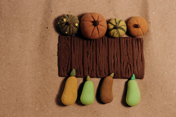 Cute miniature handmade pumpkins flat lay on crafted brown paper.