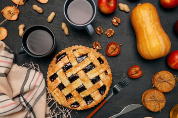 Thanksgiving pie and pumpkin on black background