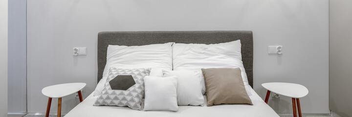 Fototapeta na wymiar Double bed in modern bedroom, panorama