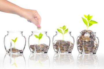 Mix coins in clear bottle on white background,Business investment growth concept,saving concept,Hand putting coins and seed in clear jar over white background