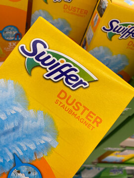 Viersen, Germany - July 9. 2020: View on carton box Swiffer duster dust clothes in front of shelf in german supermarket (focus on box)