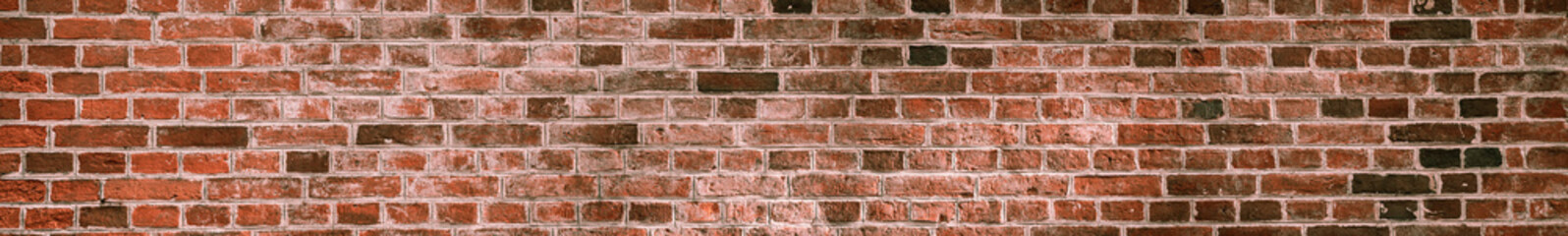 Panorama of a soiled dirty red brick wall. Old dilapidated brick wall surface.