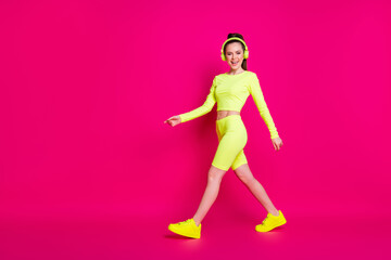 Fototapeta na wymiar Full length body size view of her she nice attractive thin slender sporty cheerful cheery girl listening different pop music walking isolated bright vivid shine vibrant pink fuchsia color background