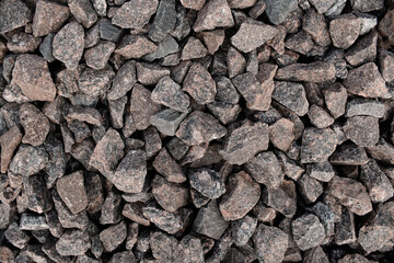 Texture of a large stone granite. Background of a stone embankment close-up, top view.