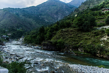 Fototapeta na wymiar River running in the Tirthan Valley