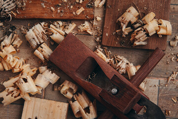 A hand planer and wood shavings on the tile floor