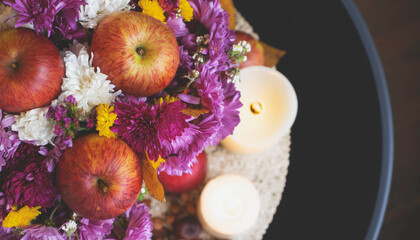 Autumn bouquet of flowers and apples. Autumn bright background with apples, chrysontema, dry leaves. September October November. Seasonal autumn background with yellow and orange colors.