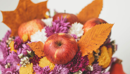 Autumn bouquet of flowers and apples. Autumn bright background with apples, chrysontema, dry leaves. September October November. Seasonal autumn background with yellow and orange colors.