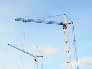 Construction cranes against the sky