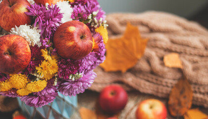 Autumn bouquet of flowers and apples. Autumn bright background with apples, chrysontema, dry leaves. September October November. Seasonal autumn background with yellow and orange colors.