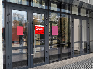 Business center closed due to COVID-19, sign with sorry in door window. Stores, restaurants, offices, other public places temporarily closed during coronavirus pandemic. Economy hit by corona virus