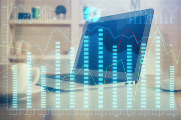 Financial graph colorful drawing and table with computer on background. Double exposure. Concept of...