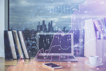 Financial graph colorful drawing and table with computer on background. Double exposure. Concept of...