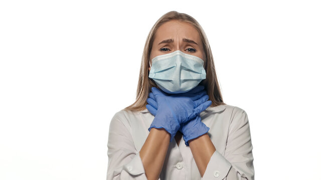 Young nurse in mask get sick. Isolated. High quality photo