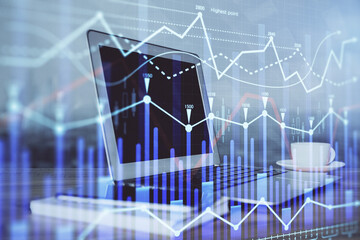 Stock market graph on background with desk and personal computer. Multi exposure. Concept of financial analysis.