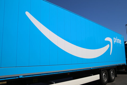 Rheinberg, Germany - August 8. 2020: View on isolated blue truck trailer with Amazon prime logo and lettering (focus on left)