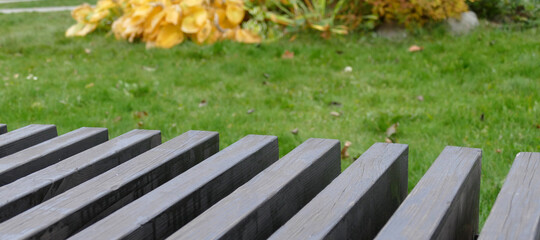 Parallel plank bench element on grass background