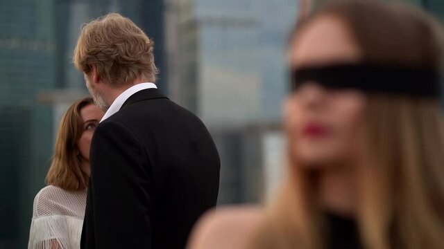 Representation of infidelity in a relationship, the girl stands as blind and does not see how her man is with another woman