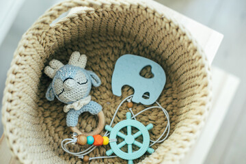 Baby stuff and accessories in knitted basket. Eco friendly, zero waste concept.