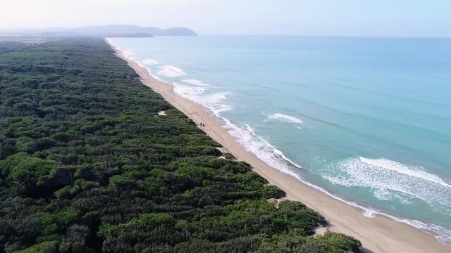 Drone view of Rimigliano beach (dog beach) in Tuscany, San Vincenzo (Italy). To the south the promontory of Piombino is visible, while to the west the Island of Elba