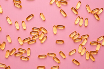 Vitamins Omega 3 6 9 fish oil , vitamin D on a pink background for health lifestyle