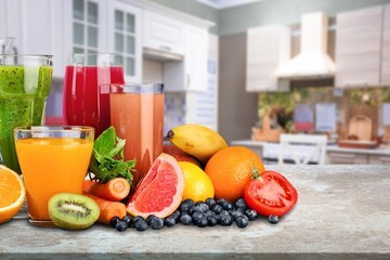 Composition of fruits and glasses of juice on desk