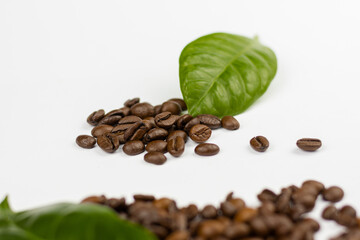 coffee beans and leaves on white background
