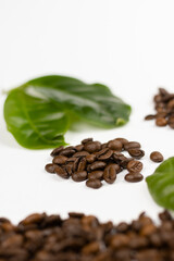 coffee beans and leaves on white background