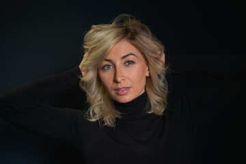 Beautiful young blonde woman with blue eyes isolated on back 