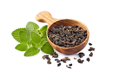 Heap of dry  green tea and fresh peppermint on background, isolated on white. Fresh lemon balm leaves, melissa isolated on white background.