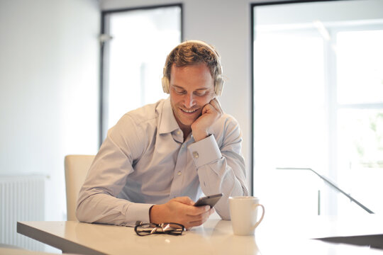 man in the office listens to music with headphones