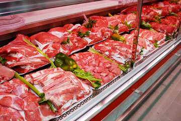 Fresh and raw meat department. Grocery shop shelves with products inside a grocery store market in Rome in Italy.