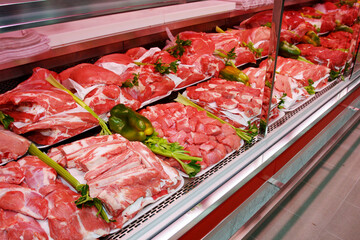 Fresh and raw meat department. Grocery shop shelves with products inside a grocery store market in...
