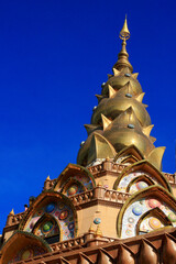 Fototapeta na wymiar Golden pagoda decorated with stones of various colors.