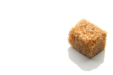 Pieces of natural brown sugar on a white background. copy space