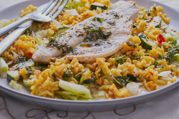 Sea bass fillet with rice and vegetables.