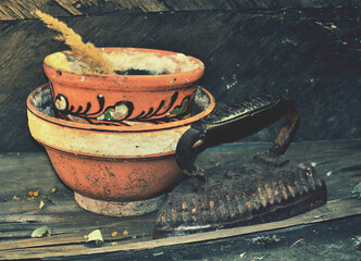 Old pot and iron with rotten wood