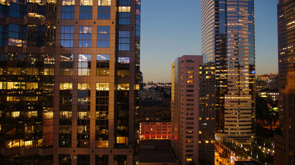 Fototapeta na wymiar View of skyscrapers lighting up at night from hotel window in Seattle, Washington