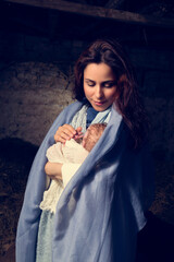 Live Christmas nativity scene in an old barn - Reenactment play with authentic costumes.  The baby is a doll.