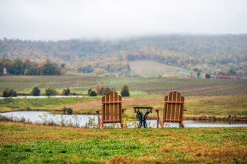 Empty two romantic wooden chairs in autumn fall foliage season countryside at Charlottesville...