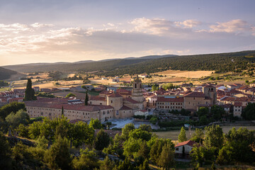 Fototapeta na wymiar City landscape of Santo Domingo de Silos from a rock on the top of the hill and the Monastery of Silos in the city center at sunset, Burgos, Spain