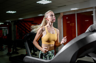 Fototapeta na wymiar young girl runs on a treadmill.