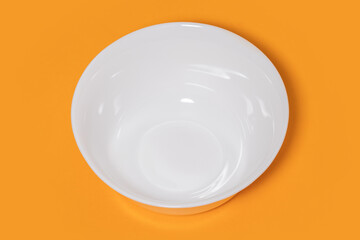 White ceramic bowl on yellow background