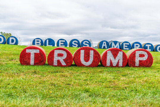 Washington, USA - October 27, 2020: Front of God Bless America and Donald Trump slogan text during US presidential election painted on hay bales in Virginia rural countryside farm field