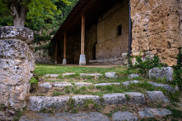 Stone stairs on the courtyard of the church of Santa Maria in the background on a cloudy day in Orbaneja del Castillo, Burgos, Spain
