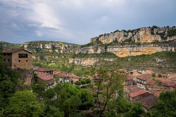 Fototapeta na wymiar Top view cityscape of the picturesque town of Orbaneja del Castillo with a stormy sky, Burgos, Spain