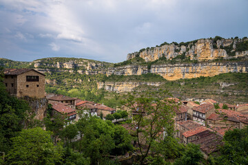 Obraz premium Top view cityscape of the picturesque town of Orbaneja del Castillo with a stormy sky, Burgos, Spain