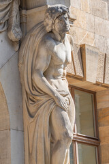 Obraz premium Statue of powerful and emotional atlas of Renaissance Era as support for building facade in Dresden, Germany, details, closeup