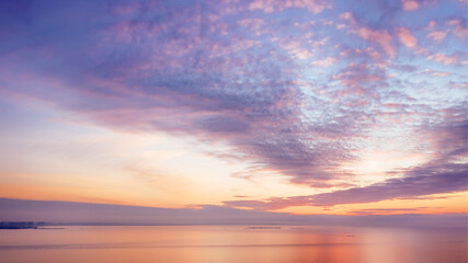 Naklejka na ściany i meble Colored romantic sky over sea at sunset